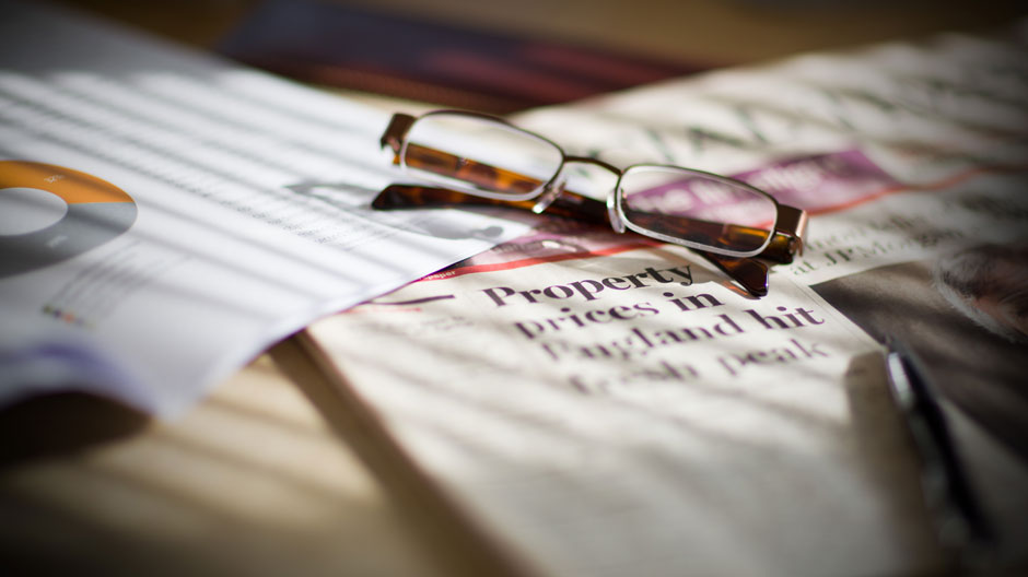 Glasses lying on financial papers
