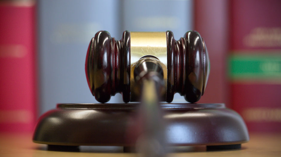 Gavel on table with legal books in the background