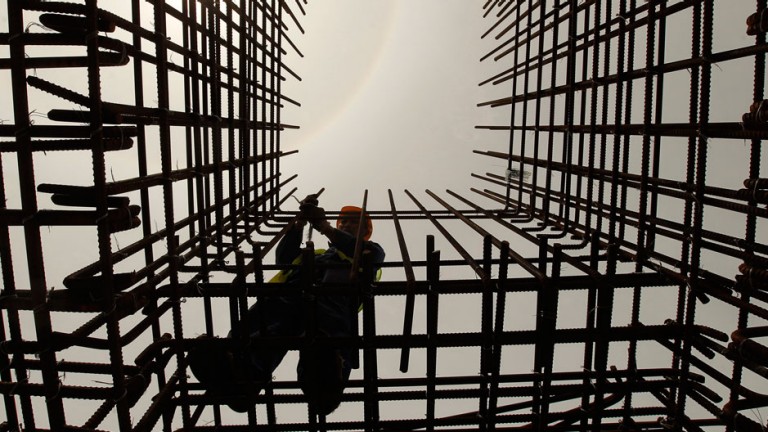 An employee works at a construction site of a Colombo port in Colombo February 13, 2013